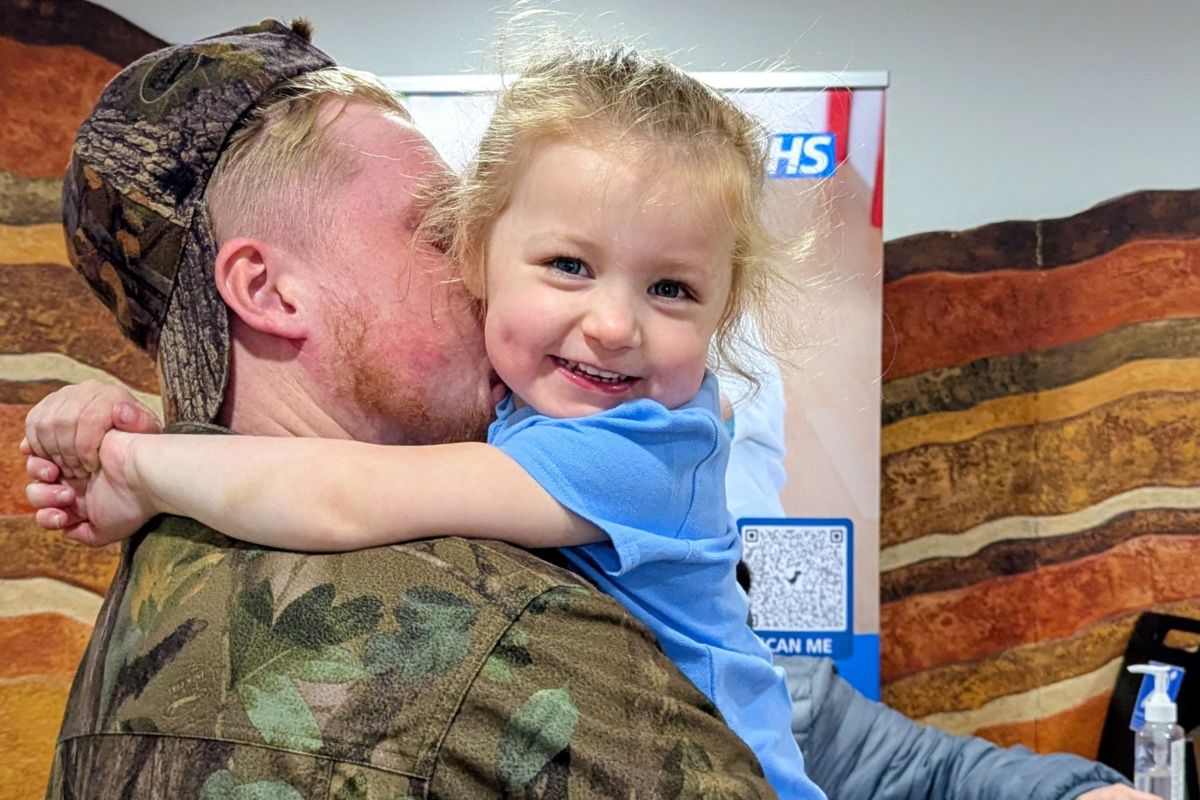 Dad cuddling little girl at Middlesbrough Family Hubs