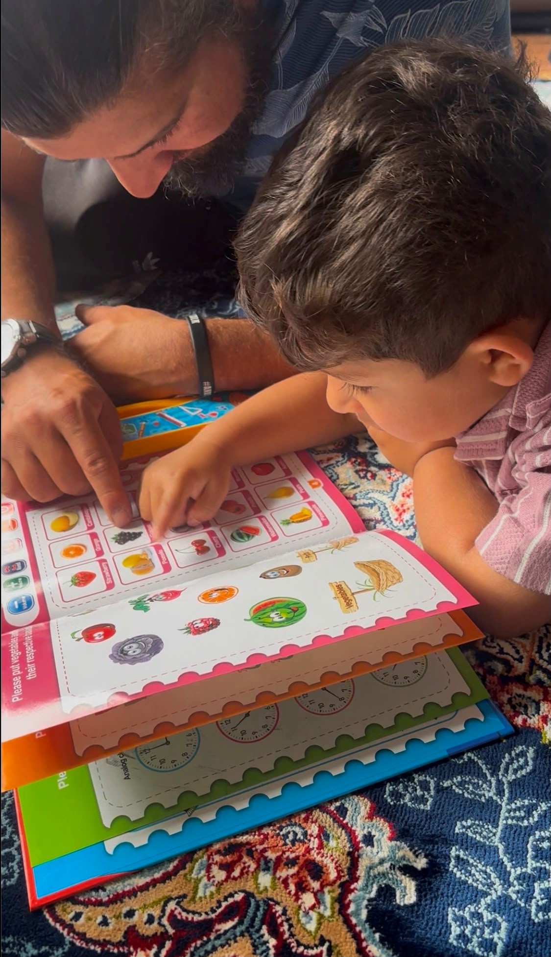 Ebaad looking at a book with his parents